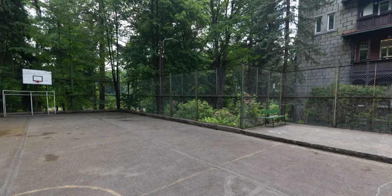 Old sports field with a basketball hoop